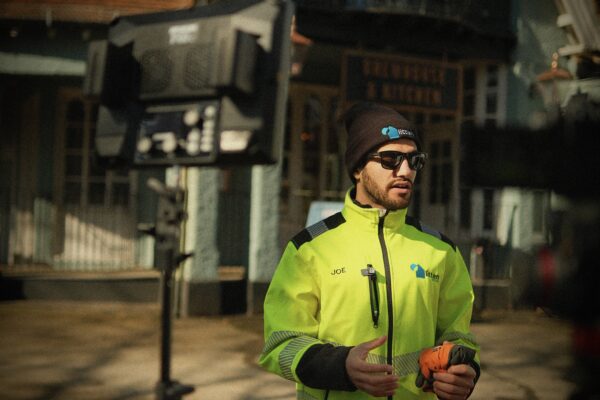 man in hi viz jacket givning interview on camera