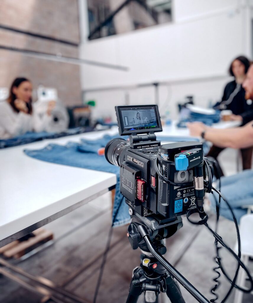 camera in front of people designing jeans